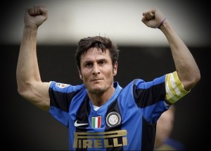 Inter Milan's Zanetti celebrates after a goal scored by his teammate Balotelli against Chievo during their Italian Serie A soccer match at the Bentegodi Stadium in Verona